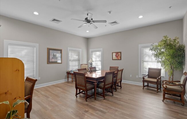 a dining room with a table and chairs and a ceiling fan