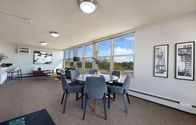 a conference room with a table and chairs and large windows