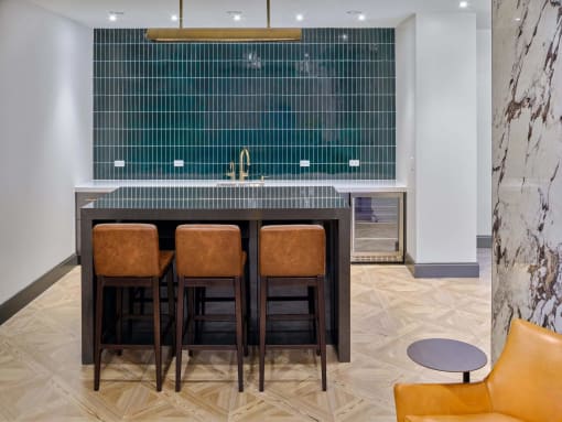 a kitchen with a wooden table and four chairs at The Encore at Ingram Manor, Pikesville, Maryland