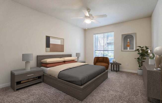 A bedroom with a bed, nightstand, and a plant.