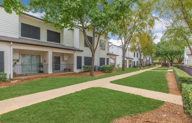our apartments have a spacious courtyard with green grass and trees