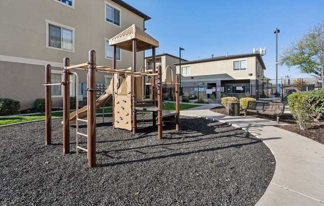 an empty playground in front of a building