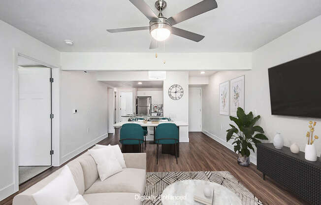A living room with a white couch and a ceiling fan.
