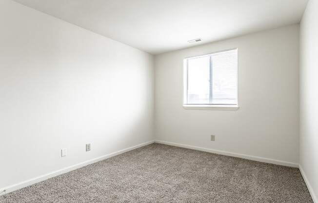 an empty room with carpet and a window at Pheasant Run in Lafayette, IN 47909