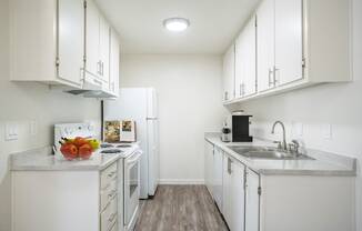 a kitchen with white cabinets and white appliances at Kirkwood Meadows, Pocatello, ID