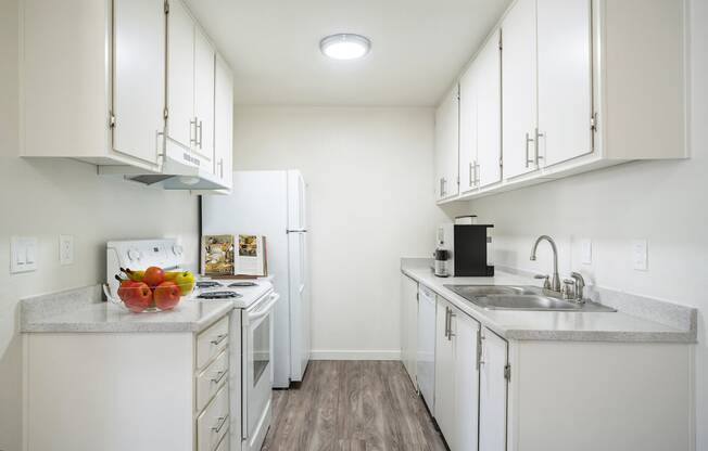 a kitchen with white cabinets and white appliances at Kirkwood Meadows, Pocatello, ID