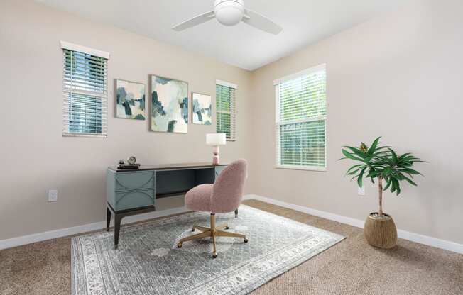 a desk with a chair and a plant in a room with beige walls and a ceiling