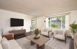 A living room with a flat screen TV mounted on the wall.