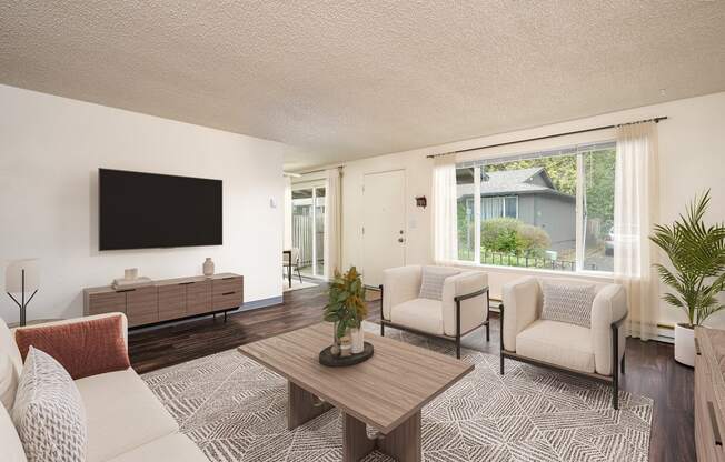 A living room with a flat screen TV mounted on the wall.
