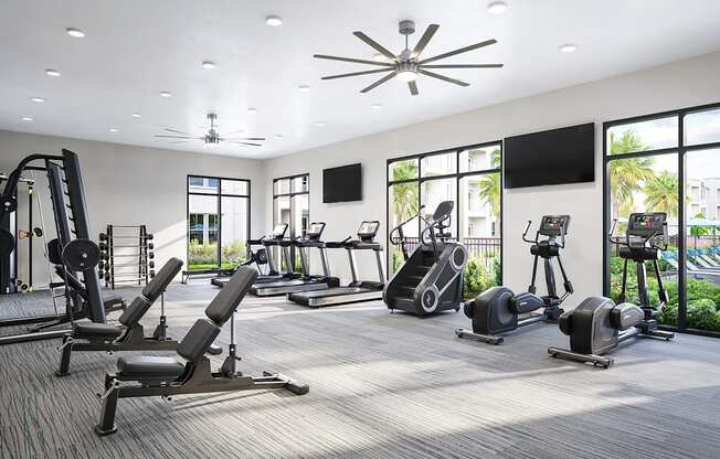 a gym with cardio equipment and windows in a building