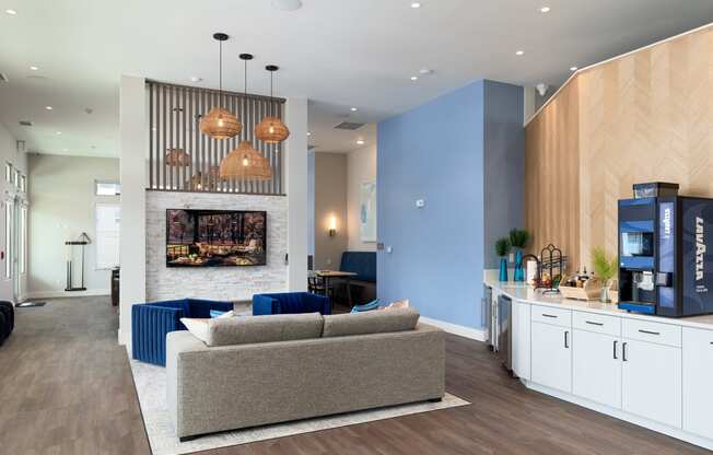 a living room with a couch and a table in front of a fireplace