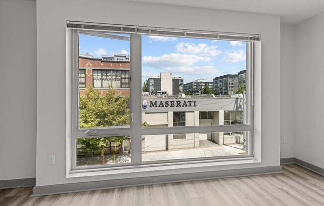 A room with a large window overlooking a city street.