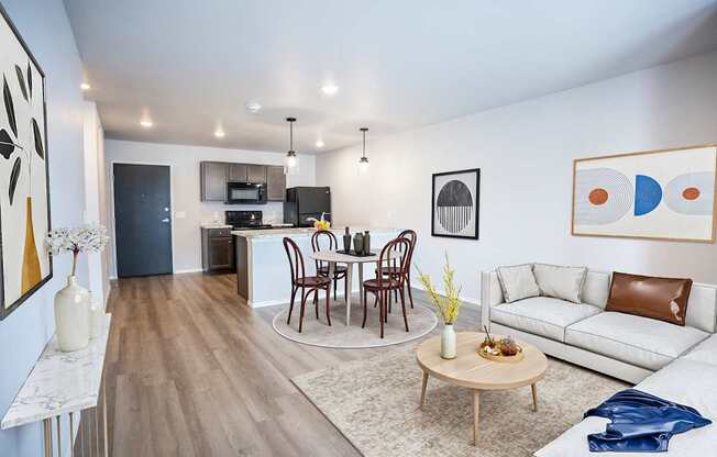 A modern living room with a dining table set up in the middle.