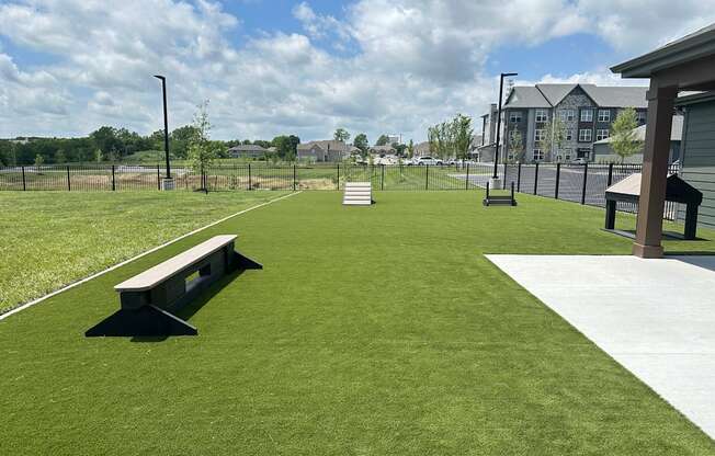 a park with a bench in the middle of a field at The Depot Raymore, MO 64083