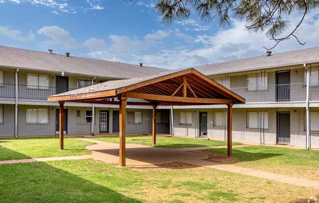 a building with a wooden pavilion in the courtyard