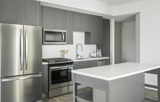 Sleek shaker cabinetry with stainless steel appliances and quartz countertops.