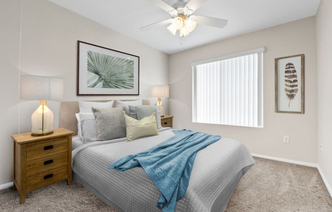 a bedroom with a large bed and a ceiling fan