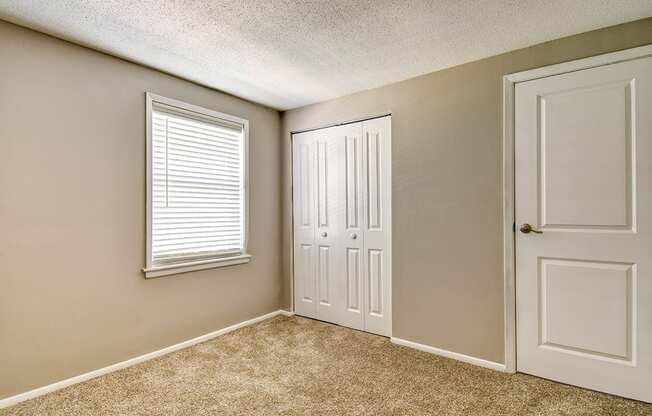 Bedroom with a closet in a 2-bed, 1-bath apartment at Ashton Brook.