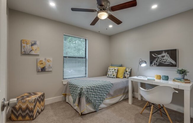 a bedroom with a bed and a ceiling fan