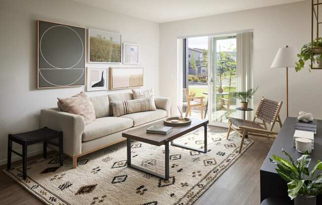 a living room with a white couch and a black and white rug