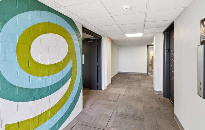 a hallway with a mural of a circle on the wall
