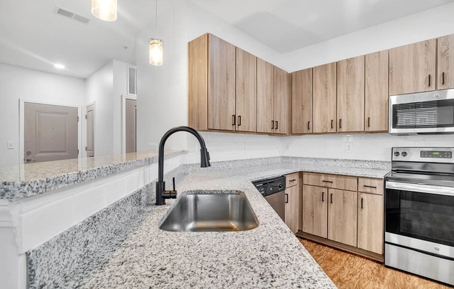 a kitchen with granite counter tops and wooden cabinets