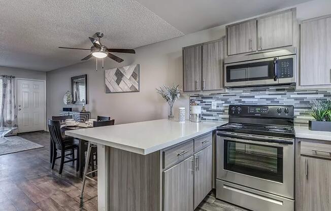 a stove top oven sitting inside of a kitchen