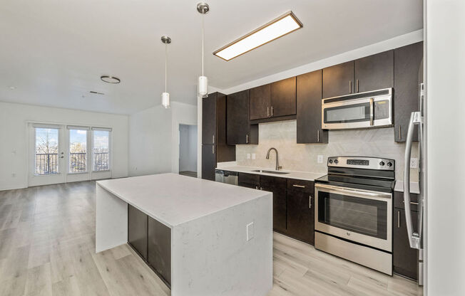 a kitchen with a white island and black cabinets