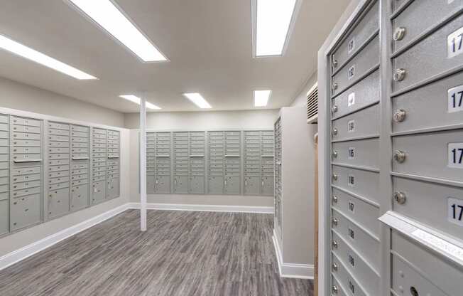 A room with a row of filing cabinets on the right and a row of filing cabinets on the left.