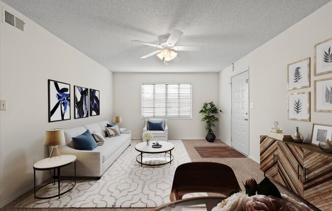 a living room with a couch and a ceiling fan