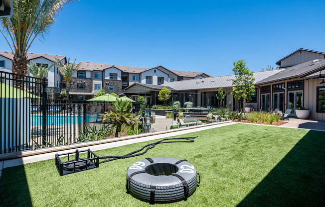 a backyard with a pool and a fire pit at The Vineyards Apartments, Porter Ranch, California
