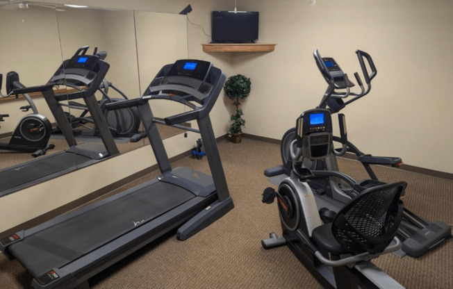 two treadmills and a treadmill in a gym