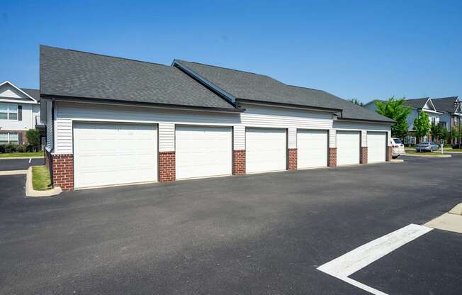 A large white garage door is on the left side of the building.