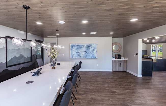 a long dining room with a long table and chairs