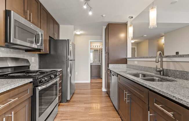 a kitchen with stainless steel appliances and granite countertops