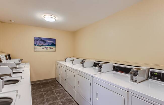 a washer and dryer room with laundry machines