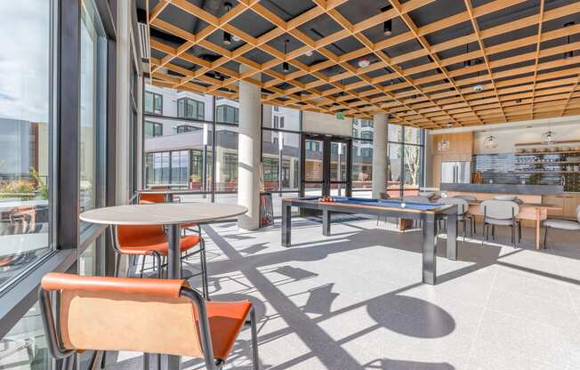 a common area with tables and chairs and a ping pong table at Marina Square, Bremerton, 98337