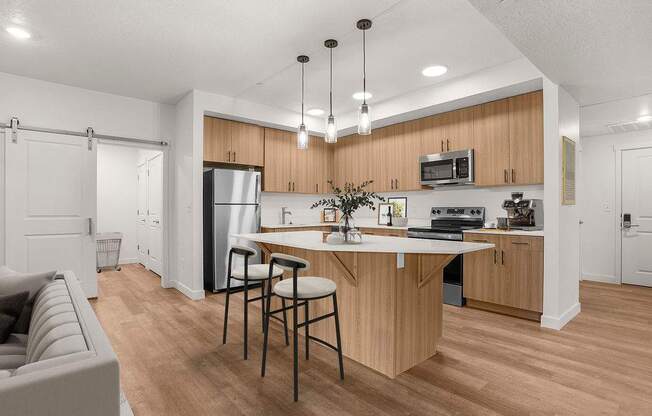 A modern kitchen with wooden cabinets and a white island.