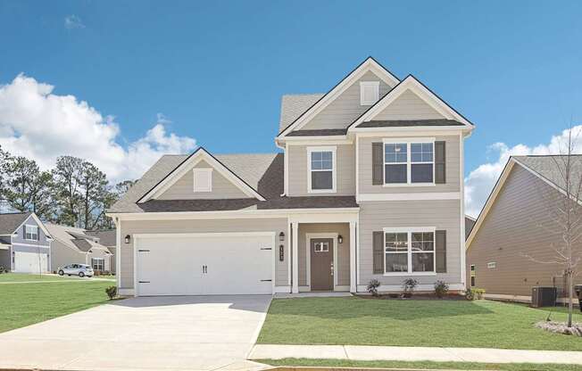 A two-story house with a garage is shown in the image.