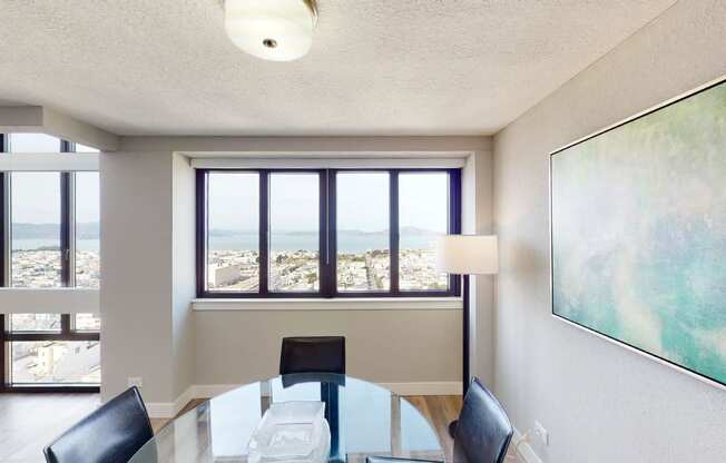 a conference room with a glass table and black chairs