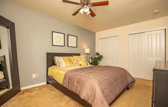 a bedroom with a bed and desk in a room