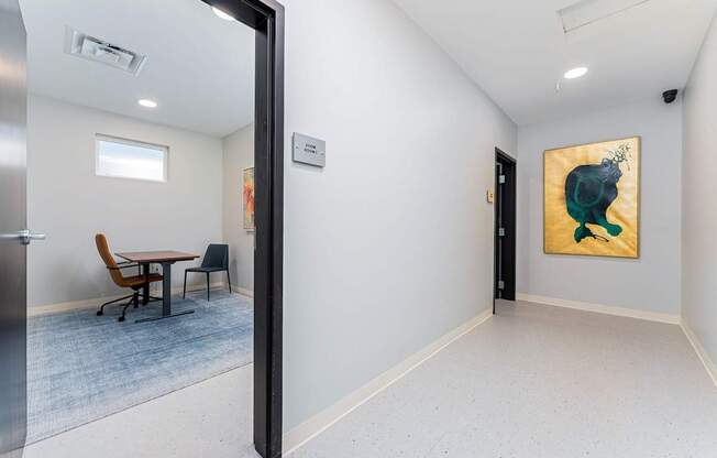 A room with a painting of a green animal on the wall.