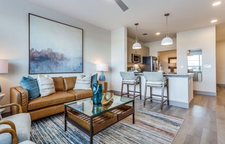 a living room with a couch and a glass coffee table