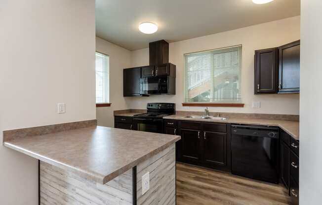 the view of a kitchen with a counter top and a sink