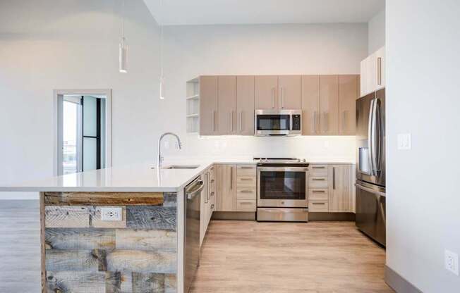 A modern kitchen with wooden cabinets and stainless steel appliances.
