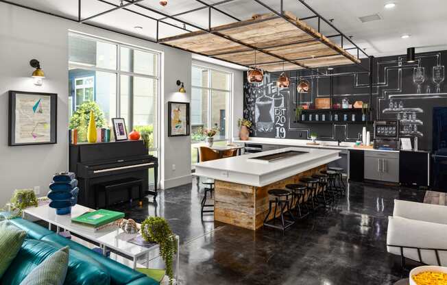 a kitchen with a large island and a piano at Abberly Noda Vista Apartment Homes, North Carolina