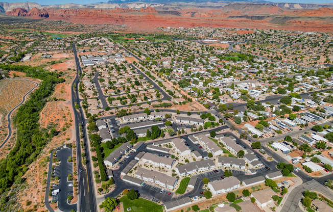 an aerial view of a city with mountains in the background