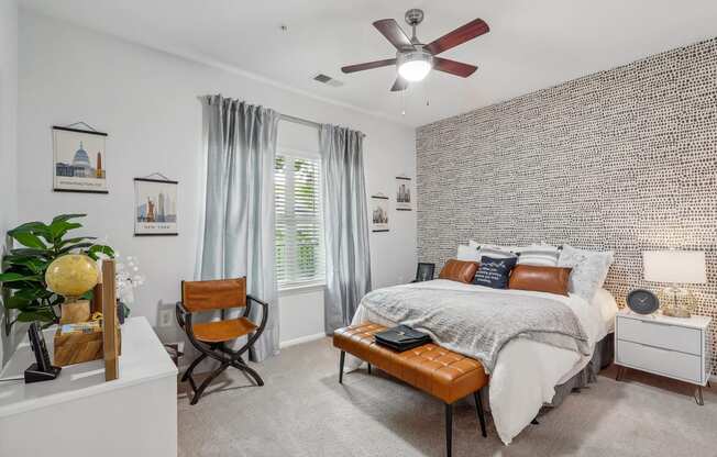 a bedroom with a large bed and a geometric wall paper on the ceiling