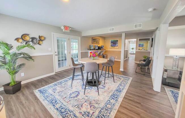 A dining room with a table and chairs.