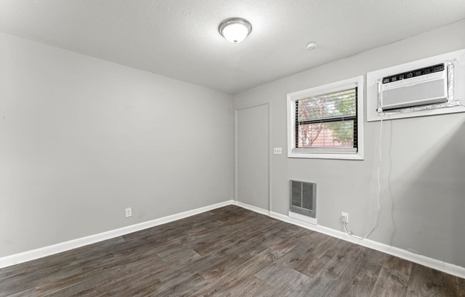 a bedroom with hardwood floors and grey walls  at Balfour 296, Lilburn, GA